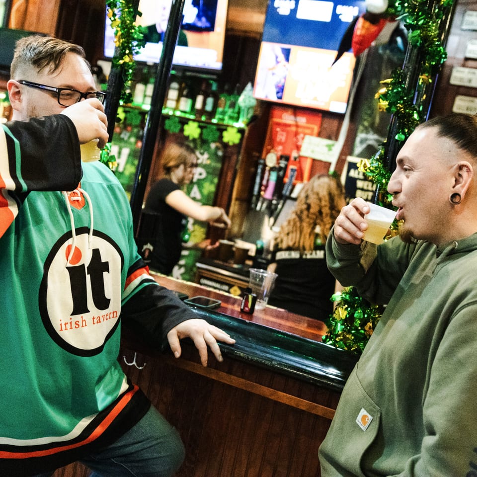 Two guests enjoying drinks at the bar