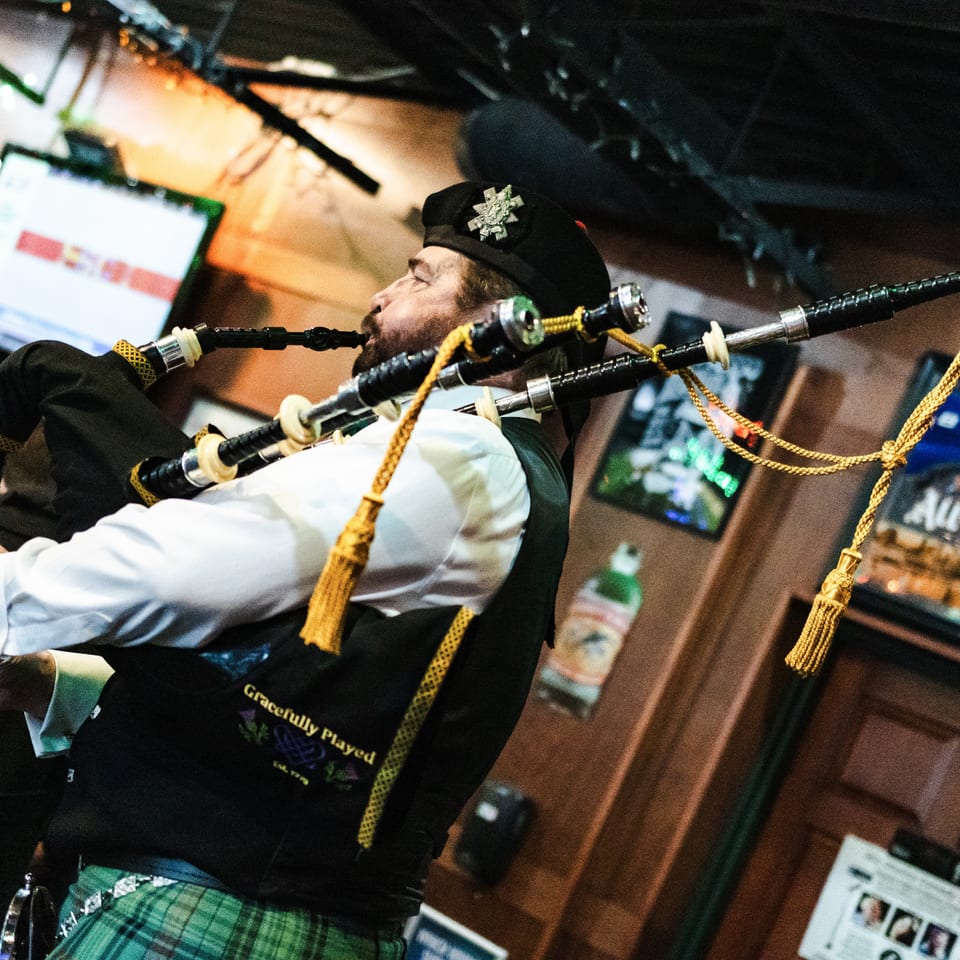 Bagpiper performing inside the tavern