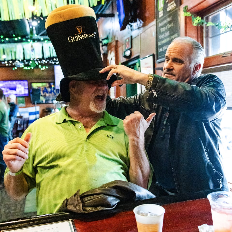 Two guests with a novelty Guinness hat at the tavern